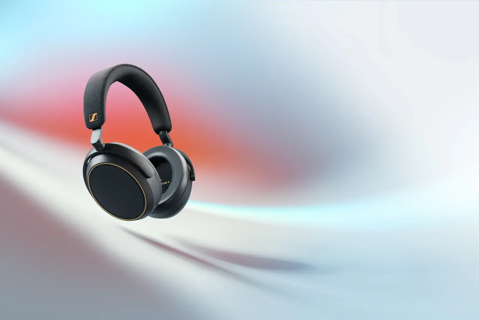 Black and copper Sennheiser MOMENTUM 4 Wireless headphones on a light abstract background